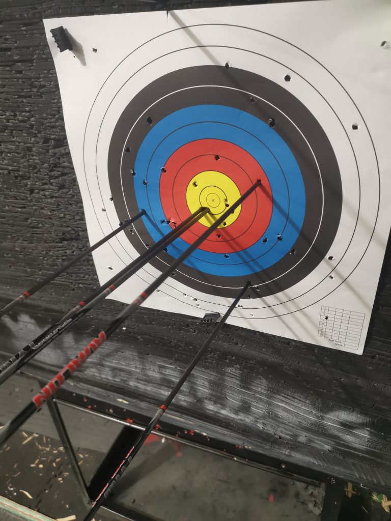 An archery targets with arrows stuck in it.